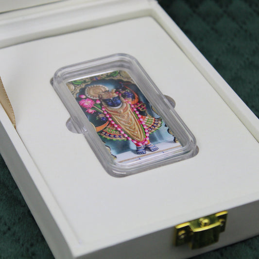 Decorative Coin in a clear plastic holder on a white box with gold latch.